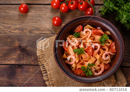 Fettuccine pasta with shrimp, cherry tomatoes, sauce, spices and herbs Fettuccine pasta with shrimp, cherry tomatoes, sauce, spices and herbs 80711018