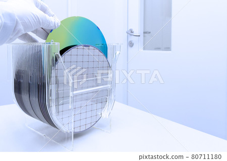 Silicon Wafers in storage box on table in clear room prepared for production of semiconductor foundry. 80711180