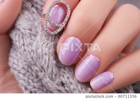 Womans hand with fashionable lavender manicure. Winter christmas nail design Womans hand with fashionable lavender manicure. Winter christmas nail design 80711356