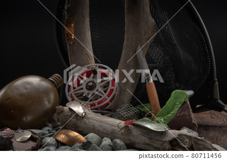 Fishing still life with old tackle. Old tree stump and stones. Vintage fishing stuff. Fishing still life with old tackle. Old tree stump and stones. Vintage fishing stuff. 80711456