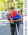 Close up of latino man wearing the cuban flag smiling at the camera 80711654