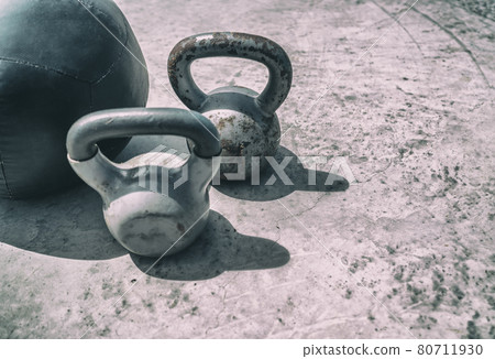 Fitness kettlebells weights gym background. Free kettlebell weight and medicine ball training workout outdoor place. Kettlebells heavy weight for weightlifting cross training Fitness kettlebells weights gym background. Free kettlebell weight and medicine ball training workout outdoor place. Kettlebells heavy weight for weightlifting cross training 80711930