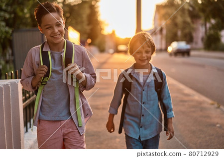 School boys running to school. School boys having fun after school. School boys running to school. School boys having fun after school. 80712929