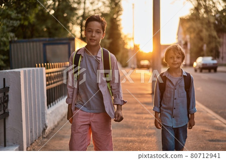 School boys running to school. School boys having fun after school. 80712941