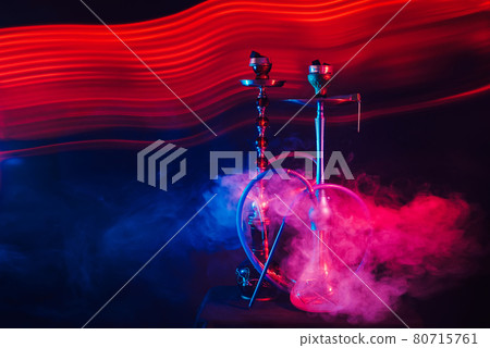 smoky Turkish hookahs with coals on bowls and water in flasks smoky Turkish hookahs with coals on bowls and water in flasks 80715761
