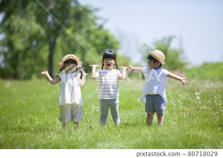 Three girls playing in a lawn park Three girls playing in a lawn park 80718029