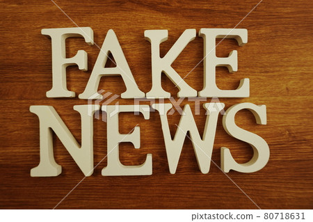 Fake News word alphabet letters on wooden background Fake News word alphabet letters on wooden background 80718631