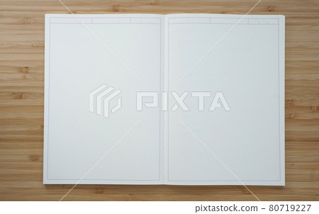A white notebook spread on a wood-grained desk 80719227