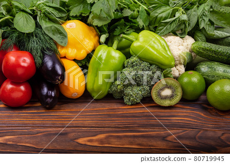 Flat lay with various vegetables on wooden table. Ingredients 80719945