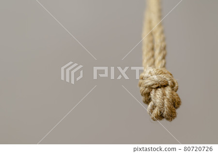 Jute rope hanging from above with knots. Jute rope hanging from above with knots. 80720726