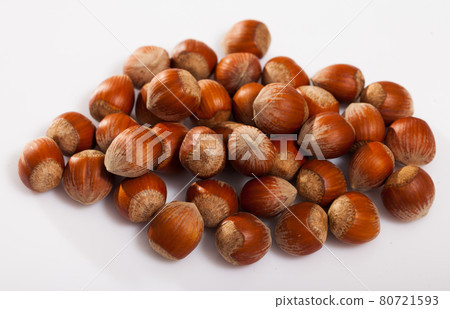 Heap of raw hazelnuts on white 80721593
