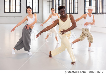 Four dancers exercising contemporary dance movements Four dancers exercising contemporary dance movements 80721617