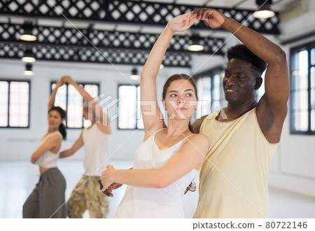 Dancing couples enjoying salsa or bachata 80722146