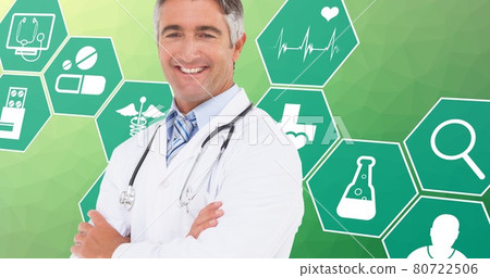 Composition of portrait of male doctor over digital icons on green background 80722506