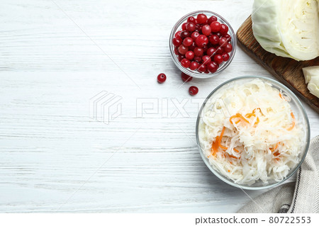 Flat lay composition with fermented cabbage on white wooden table, space for text 80722553