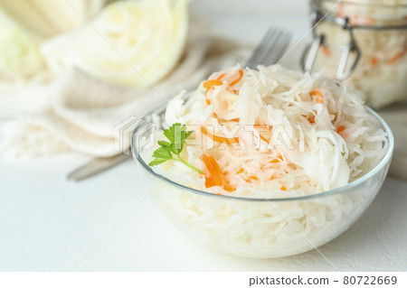 Glass bowl of tasty fermented cabbage on white table, closeup 80722669