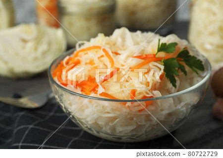 Tasty fermented cabbage with carrot on table, closeup 80722729