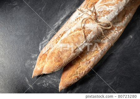 pile of baguette bread loaves tied with rope pile of baguette bread loaves tied with rope 80723280