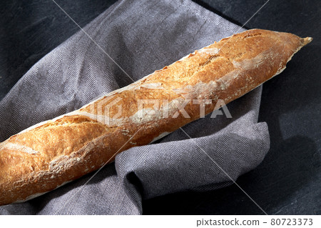 close up of baguette bread on kitchen towel close up of baguette bread on kitchen towel 80723373