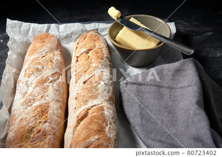 close up of bread, butter and knife on towel close up of bread, butter and knife on towel 80723402