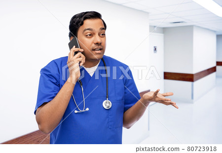 indian doctor or male nurse calling on smartphone indian doctor or male nurse calling on smartphone 80723918