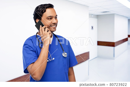smiling doctor or male nurse calling on smartphone 80723922