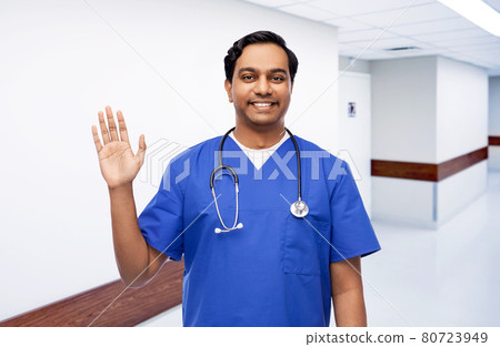 doctor or male nurse with stethoscope waving hand doctor or male nurse with stethoscope waving hand 80723949