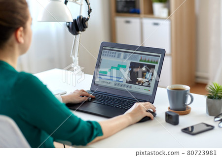 woman with video editor program on laptop at home woman with video editor program on laptop at home 80723981