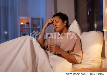 stressed african woman lying in bed at night 80723987