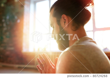 close up of man meditating at yoga studio 80724268
