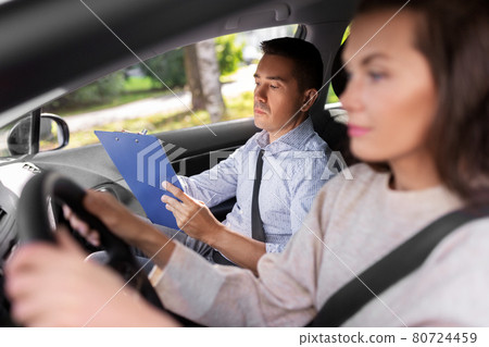 car driving school instructor and young driver 80724459