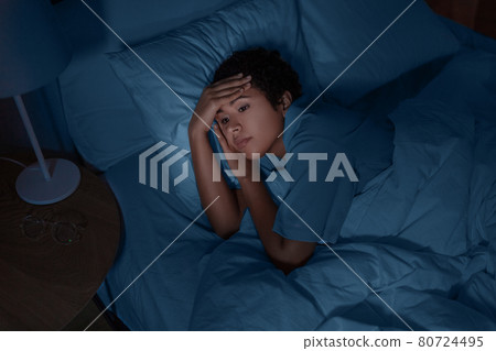 sleepless african woman lying in bed at night sleepless african woman lying in bed at night 80724495