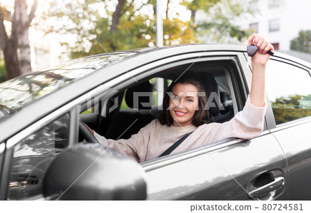 woman or female driver with car key in city woman or female driver with car key in city 80724581