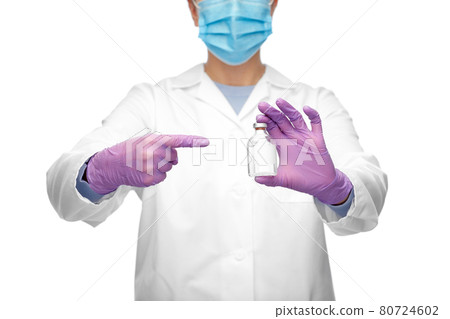 close up of doctor in mask with medicine in bottle close up of doctor in mask with medicine in bottle 80724602