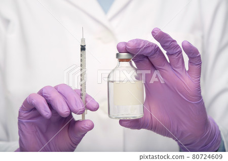 close up of doctor with medicine and syringe 80724609