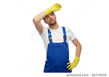 tired male worker or cleaner in overall and gloves tired male worker or cleaner in overall and gloves 80724630
