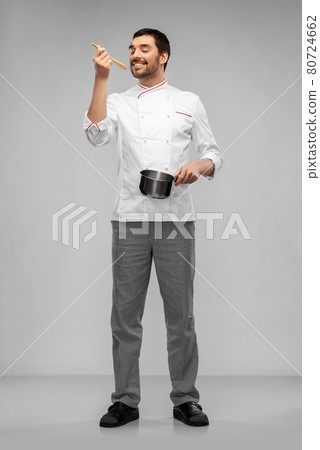 happy smiling male chef with saucepan tasting food happy smiling male chef with saucepan tasting food 80724662