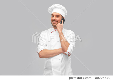 happy smiling male chef calling on smartphone 80724679