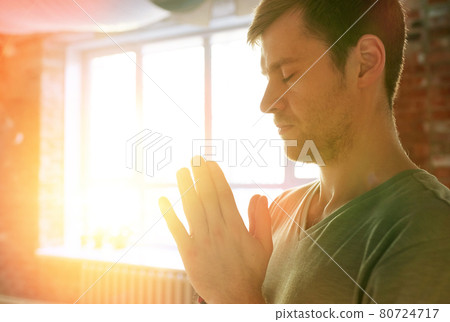 close up of man meditating at yoga studio 80724717