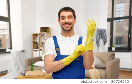 male worker or cleaner wearing gloves at home male worker or cleaner wearing gloves at home 80724930