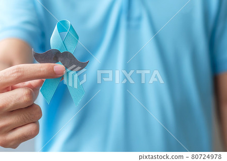 November Prostate Cancer Awareness month, Man holding Blue Ribbon with mustache for supporting people living and illness. Healthcare, International men, Father and World cancer day concept 80724978