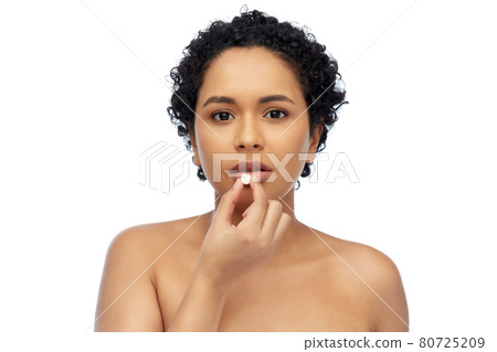 portrait of african american woman taking pill 80725209