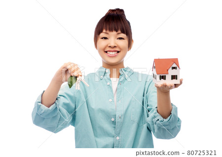 smiling asian woman holding house model and keys smiling asian woman holding house model and keys 80725321