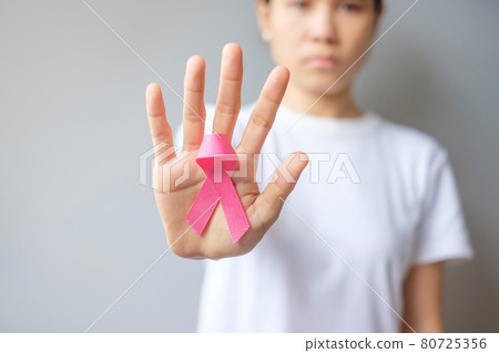 October Breast Cancer Awareness month, elderly Woman in white T- shirt with hand holding Pink Ribbon for supporting people living and illness. International Women, Mother and World cancer day concept 80725356