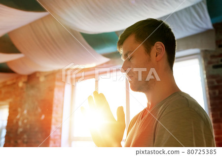 close up of man meditating at yoga studio close up of man meditating at yoga studio 80725385