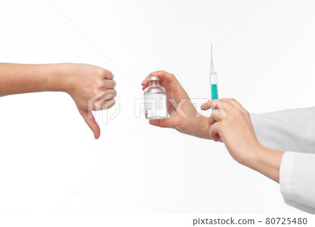 hand with medicine and showing thumbs down hand with medicine and showing thumbs down 80725480