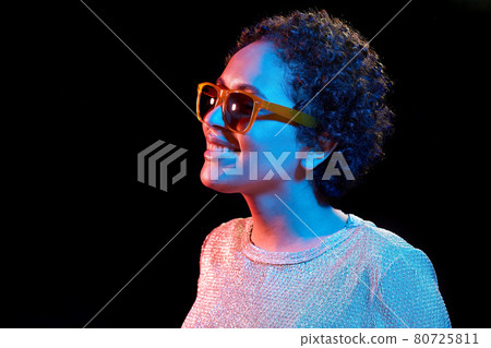 african woman in sunglasses over neon lights african woman in sunglasses over neon lights 80725811