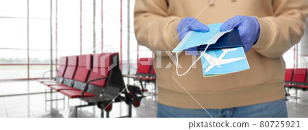 woman with mask, passport and ticket at airport woman with mask, passport and ticket at airport 80725921