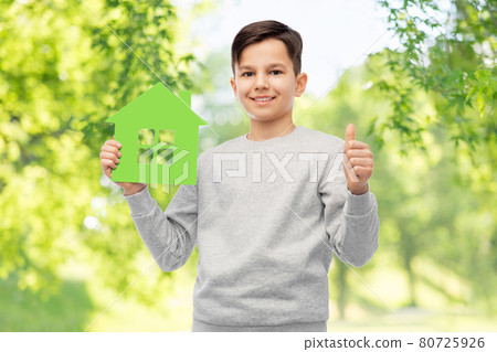smiling boy with green house and showing thumbs up smiling boy with green house and showing thumbs up 80725926