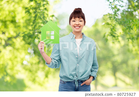 smiling asian woman holding green house 80725927